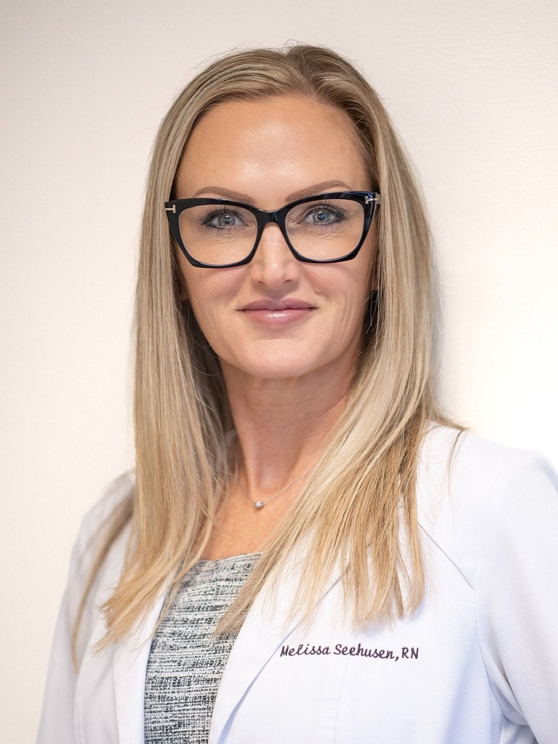 Melissa RN with glasses and blonde hair.