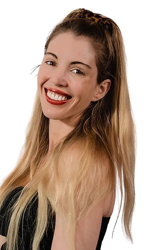 Smiling woman with long, wavy hair.