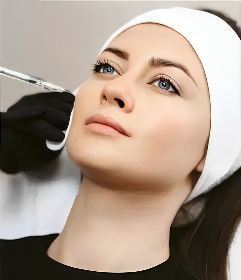 Woman receiving facial treatment in a spa.