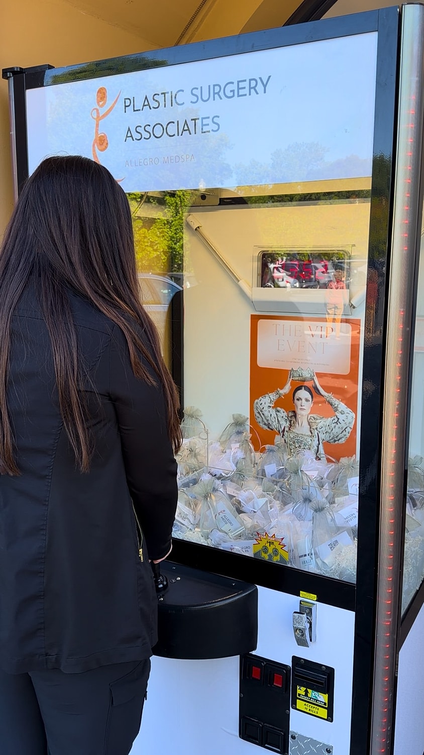 Person playing a prize vending machine game.