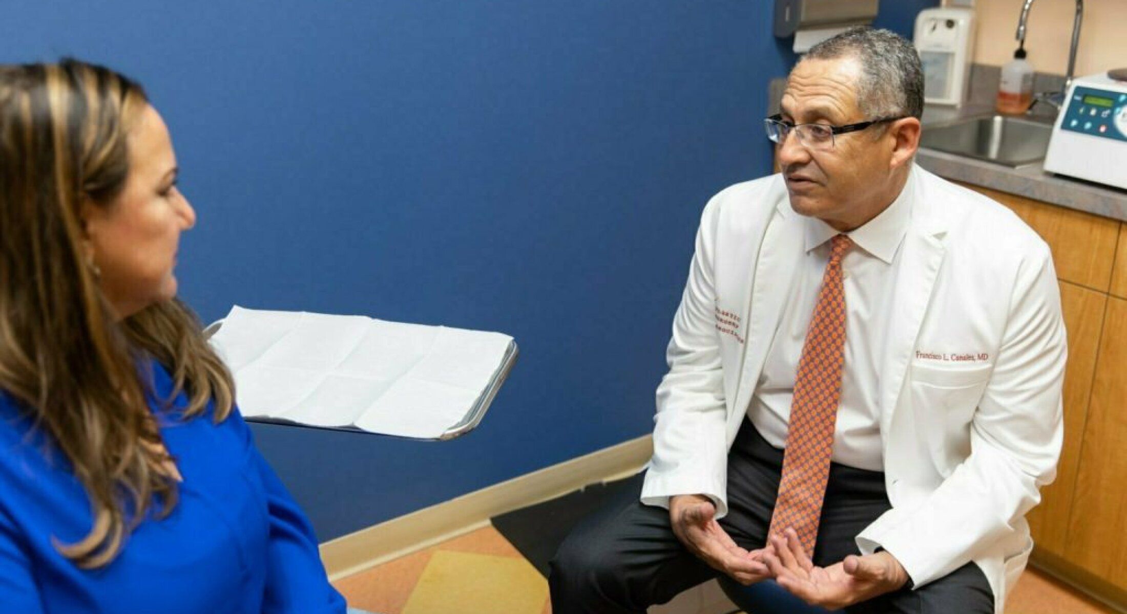 Doctor consulting with a patient in office.